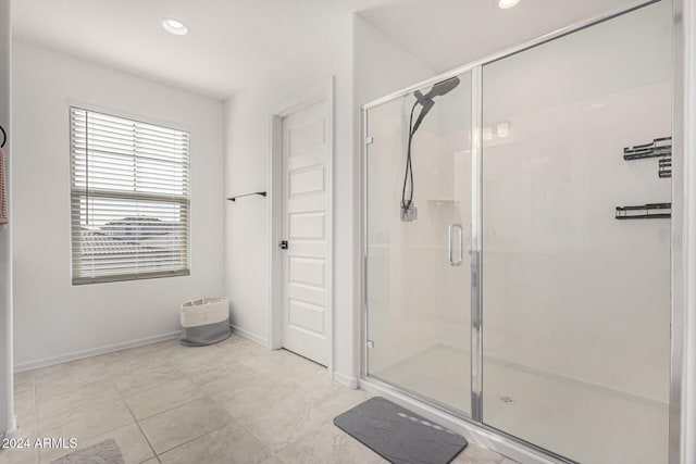 bathroom with tile patterned floors and an enclosed shower