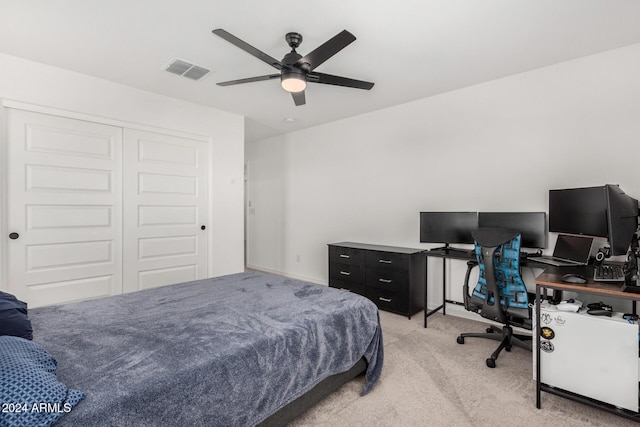 carpeted bedroom with a closet and ceiling fan