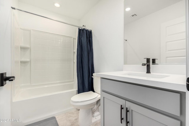 full bathroom featuring tile patterned flooring, vanity, toilet, and shower / bath combo with shower curtain