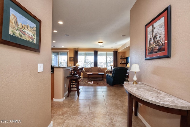 hallway featuring light tile patterned floors