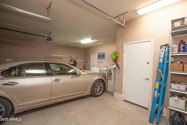 garage with a garage door opener and sink