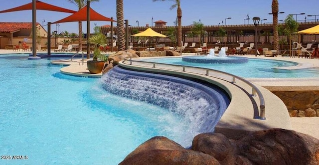 view of swimming pool with pool water feature