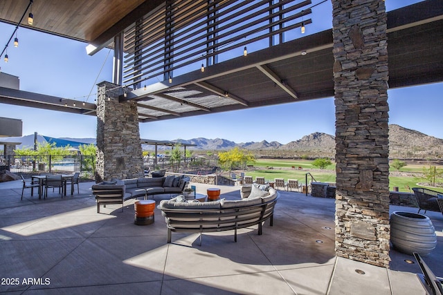 view of patio with a mountain view and an outdoor living space