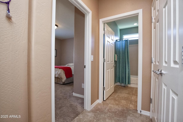 hall with light colored carpet