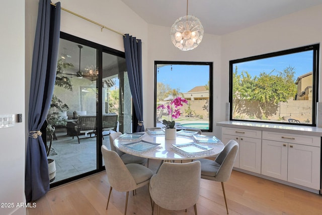 dining room with a chandelier and light hardwood / wood-style flooring