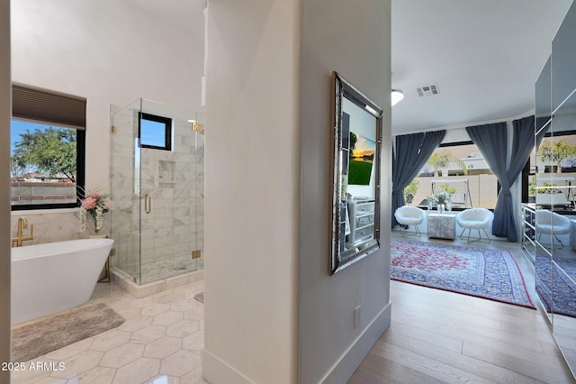 bathroom featuring separate shower and tub