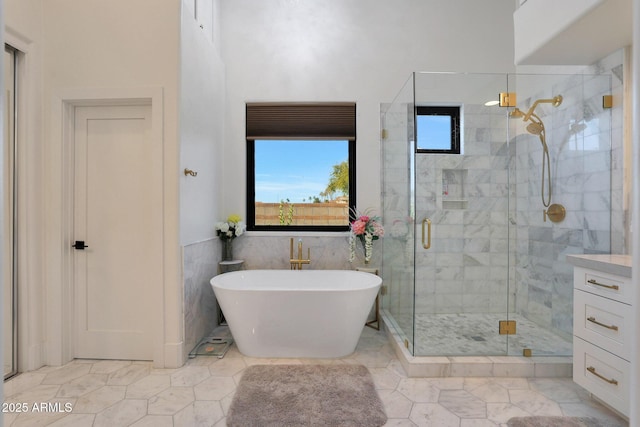 bathroom with separate shower and tub and tile walls