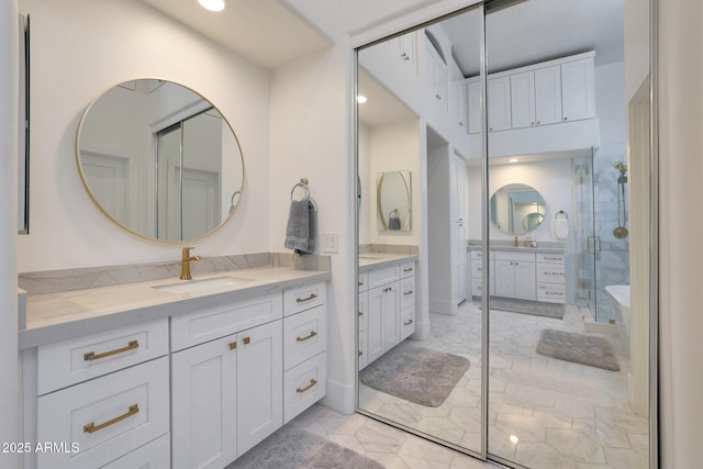 bathroom with an enclosed shower and vanity