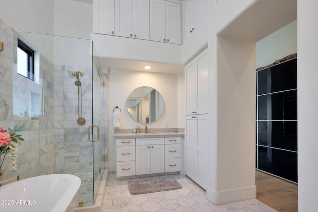 bathroom with vanity and shower with separate bathtub