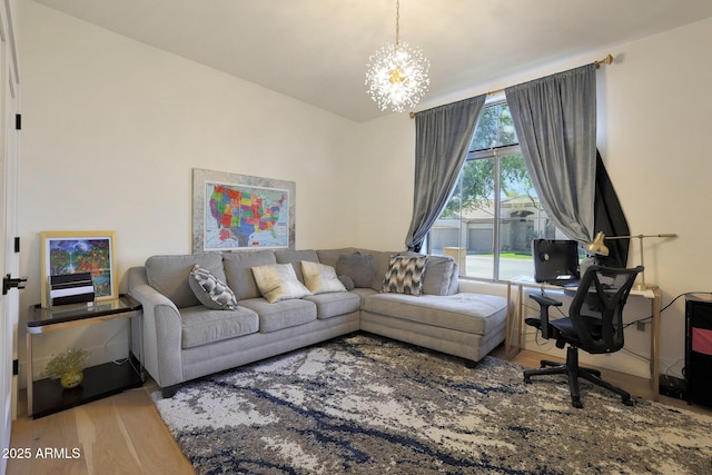 living room with light hardwood / wood-style floors and a chandelier