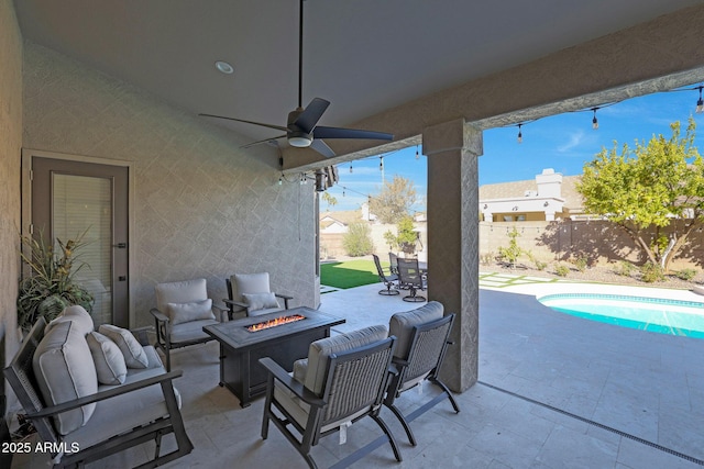 view of patio with ceiling fan, a fenced in pool, and a fire pit