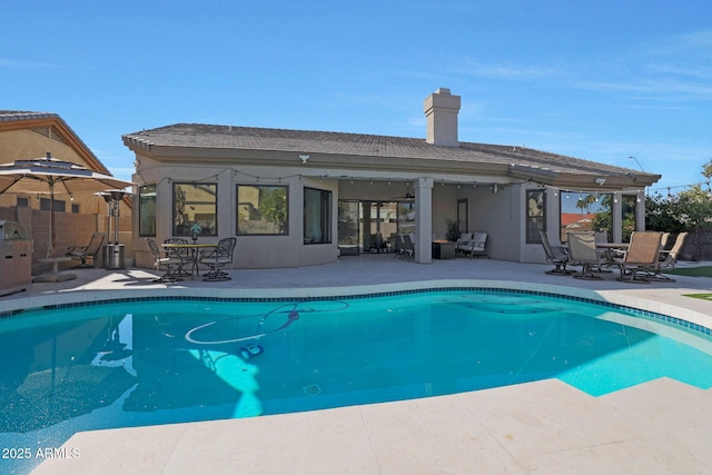 view of swimming pool featuring a patio area