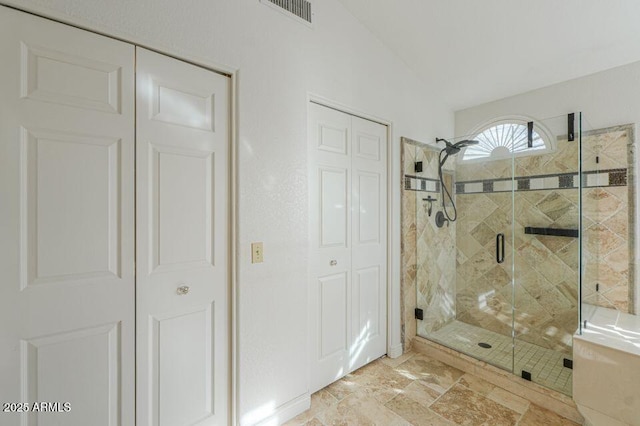 full bathroom featuring lofted ceiling, a closet, visible vents, and a stall shower