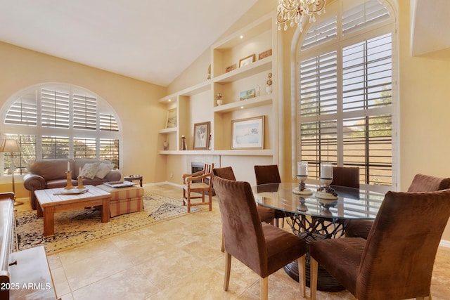 3538 E Squawbush Pl, Phoenix, AZ 85044 - dining space with built in features, a chandelier, high vaulted ceiling, baseboards, and tile patterned flooring