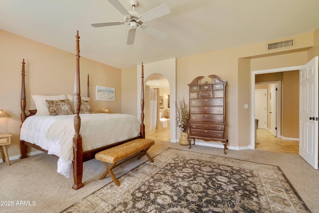 3538 E Squawbush Pl, Phoenix, AZ 85044 - bedroom with arched walkways, carpet floors, connected bathroom, baseboards, and a ceiling fan