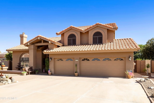 3538 E Squawbush Pl, Phoenix, AZ 85044 - mediterranean / spanish home featuring stucco siding, concrete driveway, a tiled roof, and fence