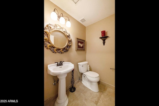 3538 E Squawbush Pl, Phoenix, AZ 85044 - bathroom featuring toilet, baseboards, a sink, tile patterned flooring, and lofted ceiling