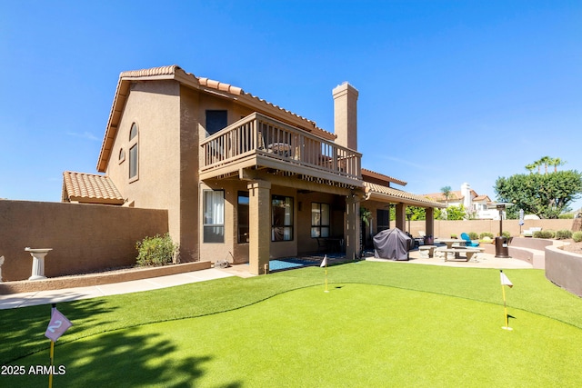 3538 E Squawbush Pl, Phoenix, AZ 85044 - back of house featuring an area to practice putting, a patio, stucco siding, and a fenced backyard