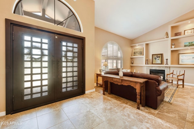 3538 E Squawbush Pl, Phoenix, AZ 85044 - foyer with french doors, baseboards, a fireplace, and high vaulted ceiling