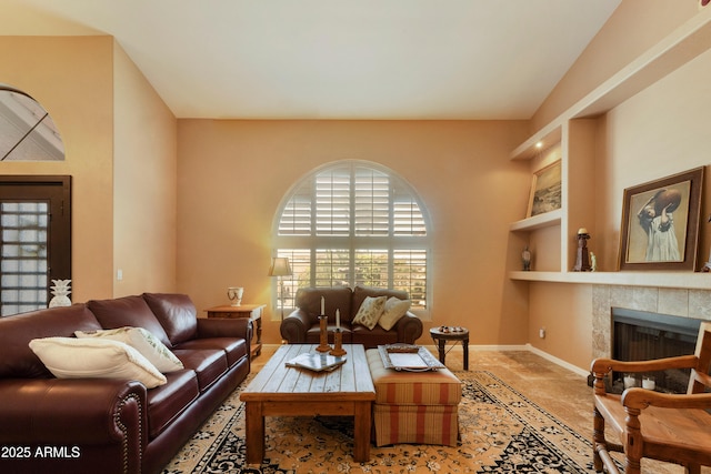 3538 E Squawbush Pl, Phoenix, AZ 85044 - living room featuring built in features, baseboards, and a tile fireplace