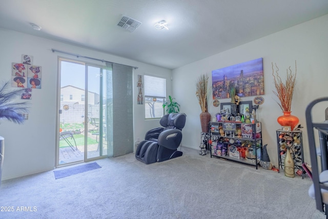 living area with carpet floors, a wealth of natural light, and visible vents