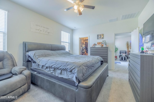 bedroom featuring a ceiling fan, visible vents, light carpet, and a spacious closet