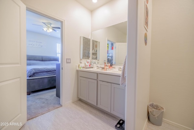 ensuite bathroom featuring vanity, ensuite bathroom, and ceiling fan