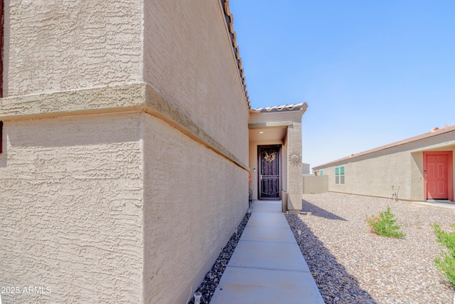 entrance to property with stucco siding