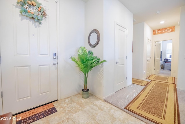 entrance foyer featuring recessed lighting and baseboards