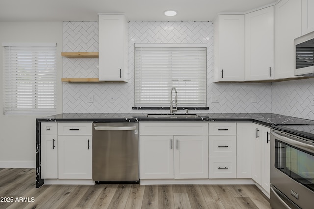 8955 W Monterey Way, Phoenix, AZ 85037 - kitchen featuring stainless steel appliances, a sink, open shelves, dark countertops, and tasteful backsplash