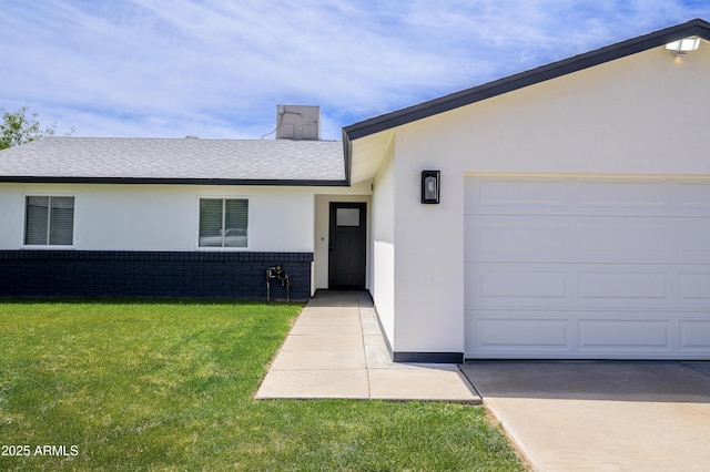 8955 W Monterey Way, Phoenix, AZ 85037 - view of front of home featuring a front lawn, stucco siding, an attached garage, a shingled roof, and brick siding