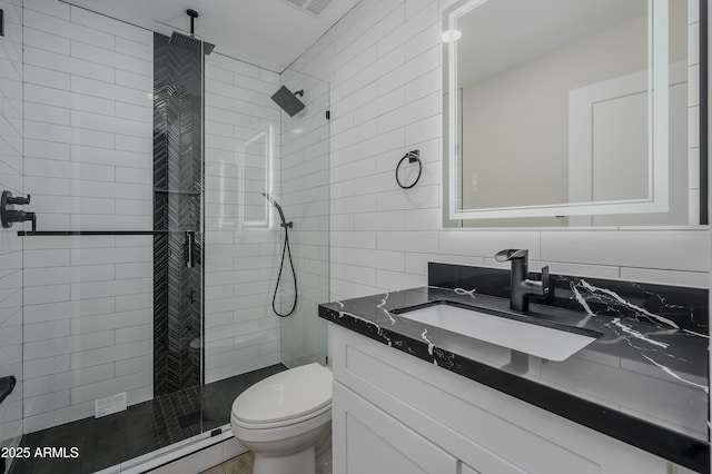 8955 W Monterey Way, Phoenix, AZ 85037 - full bath with toilet, tile walls, a stall shower, vanity, and a baseboard radiator