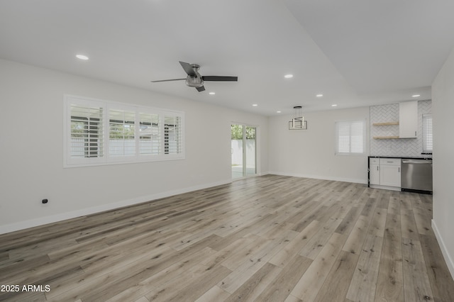8955 W Monterey Way, Phoenix, AZ 85037 - unfurnished living room with light wood finished floors, ceiling fan, recessed lighting, and baseboards