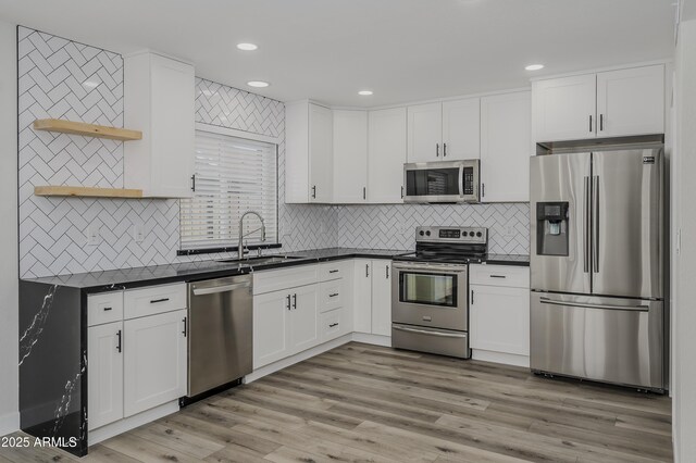 8955 W Monterey Way, Phoenix, AZ 85037 - kitchen with stainless steel appliances, a sink, open shelves, dark countertops, and recessed lighting