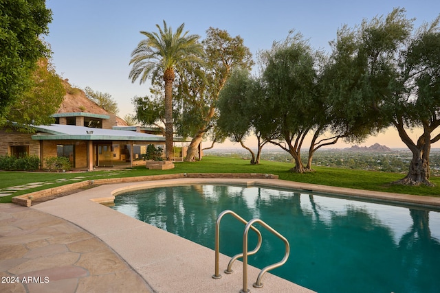 pool at dusk with a yard