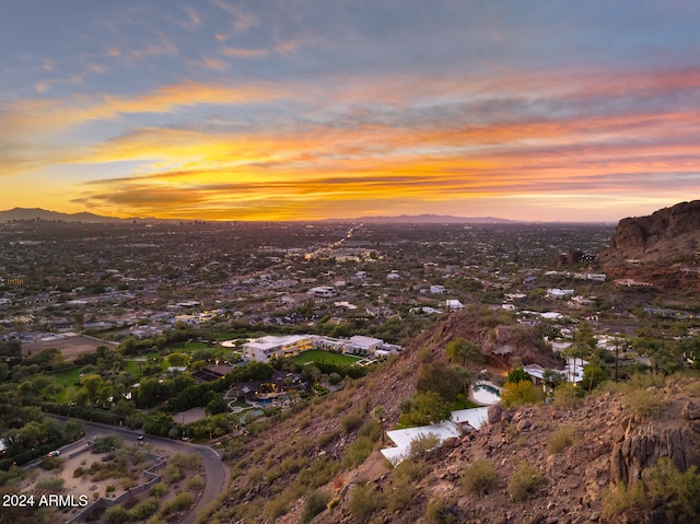 aerial view at dusk featuring a mountain view