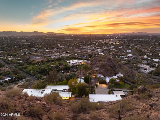 aerial view at dusk featuring a mountain view