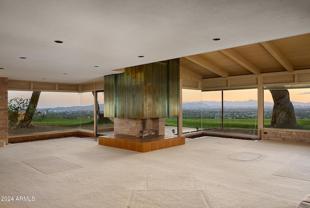 unfurnished sunroom featuring vaulted ceiling and a mountain view