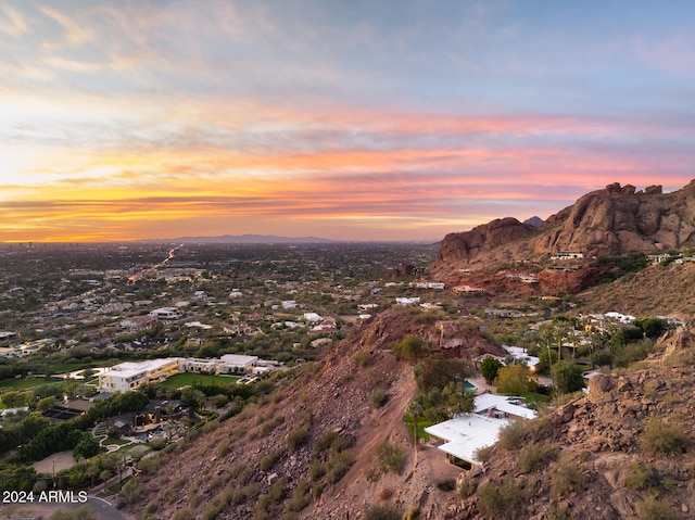 aerial view at dusk featuring a mountain view