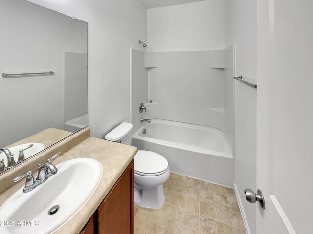 bathroom with toilet, vanity, and bathing tub / shower combination