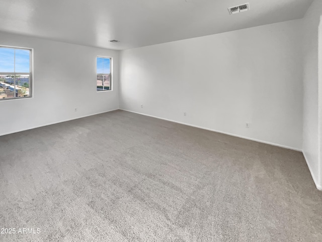 spare room with visible vents and carpet flooring