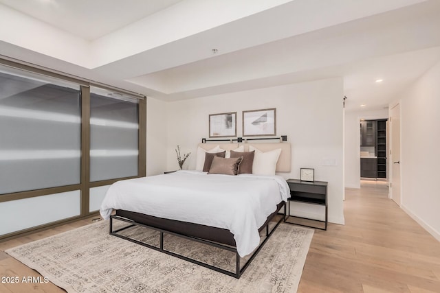bedroom with light wood-style flooring, baseboards, and recessed lighting