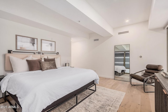 bedroom featuring light wood-style flooring and baseboards
