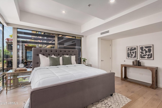 bedroom featuring light wood-style flooring, recessed lighting, and baseboards