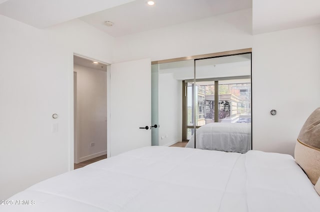 bedroom featuring recessed lighting, a closet, and baseboards