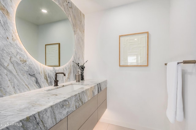 bathroom featuring decorative backsplash, tile patterned floors, vanity, and baseboards