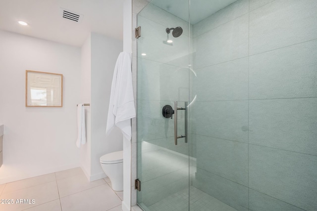 full bath with a shower stall, tile patterned floors, toilet, and baseboards