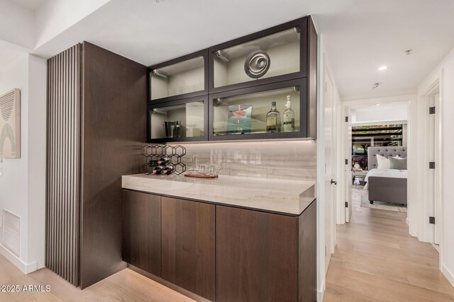 indoor dry bar featuring light wood-style flooring and recessed lighting