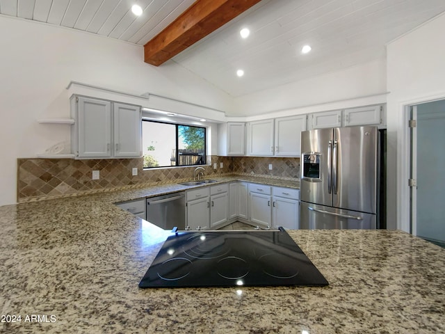 kitchen with light stone counters, vaulted ceiling with beams, open shelves, decorative backsplash, and appliances with stainless steel finishes