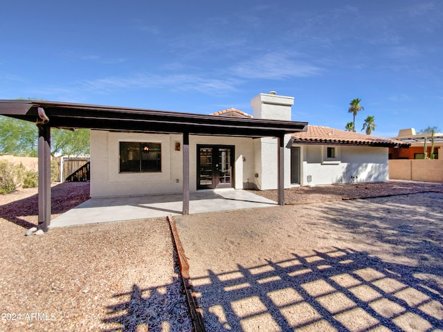 rear view of property featuring a patio area and french doors